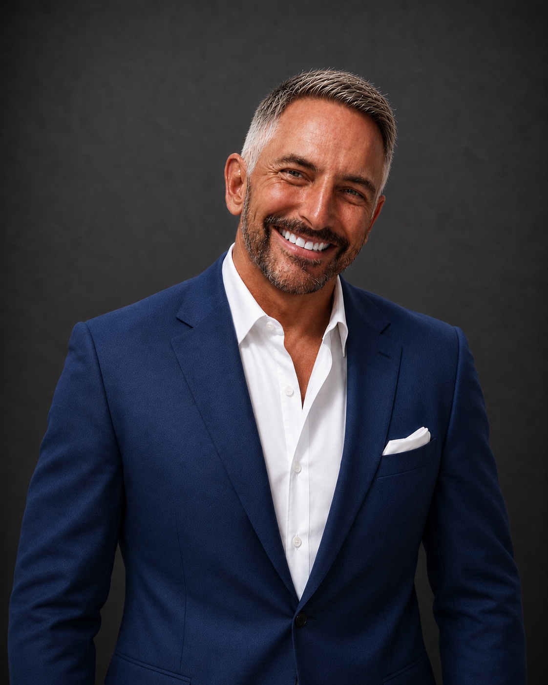 Mike Myatt in a navy jacket with a white pocket square